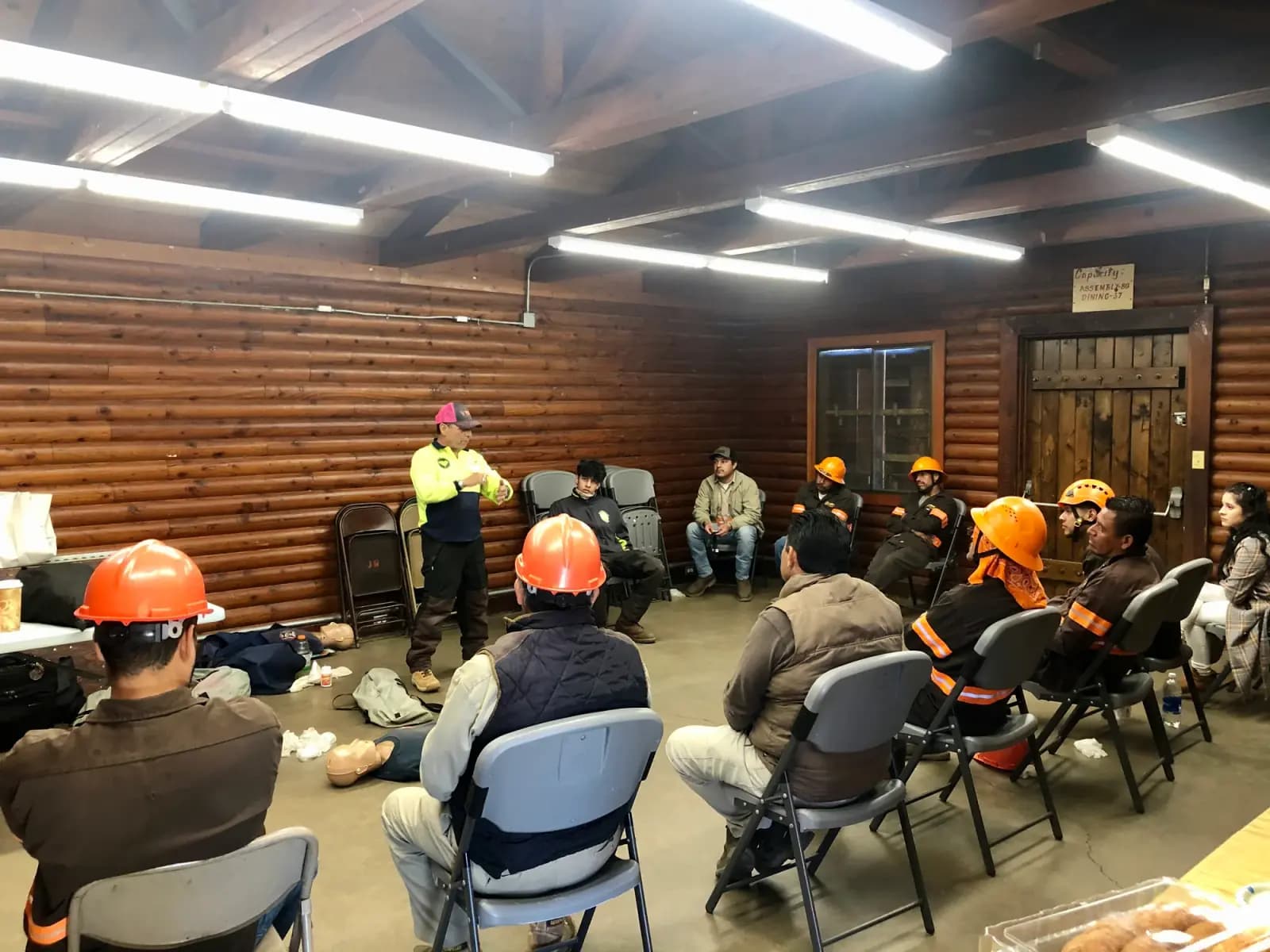 A tree crew seated in hard hats through a classroom safety training session