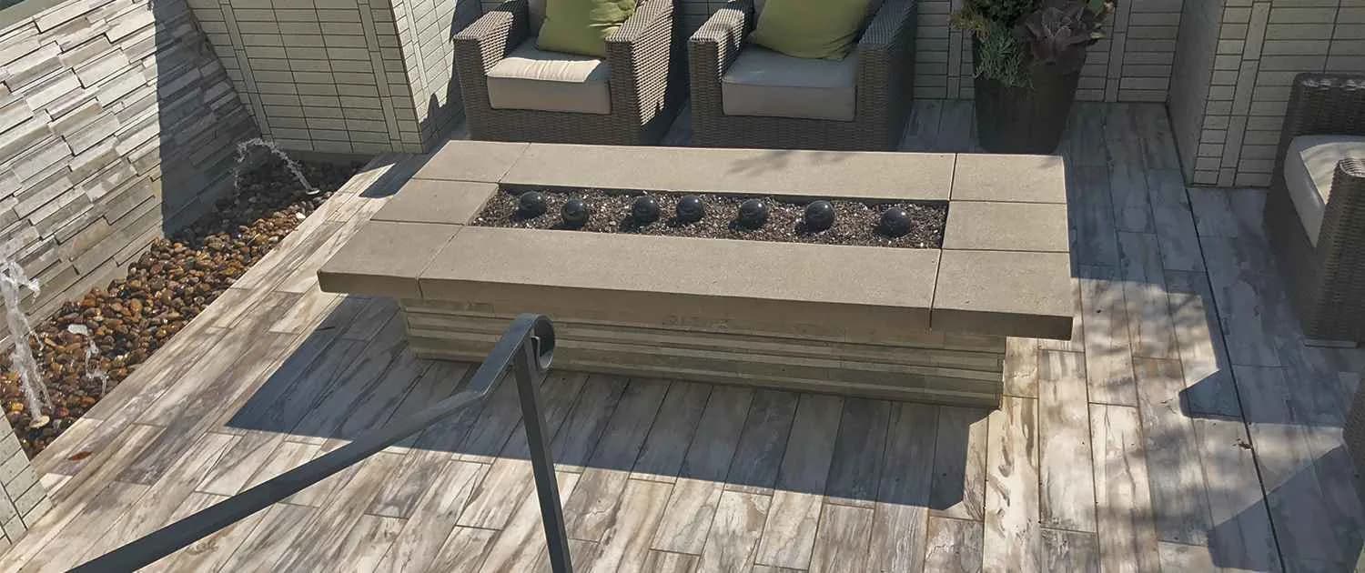 Hardscape patio with a stone fire table