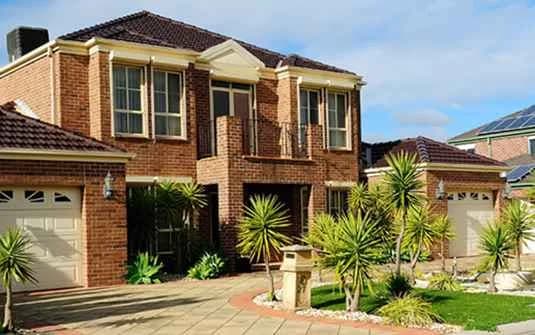 A landscaped residential yard with established planting and trimmed trees